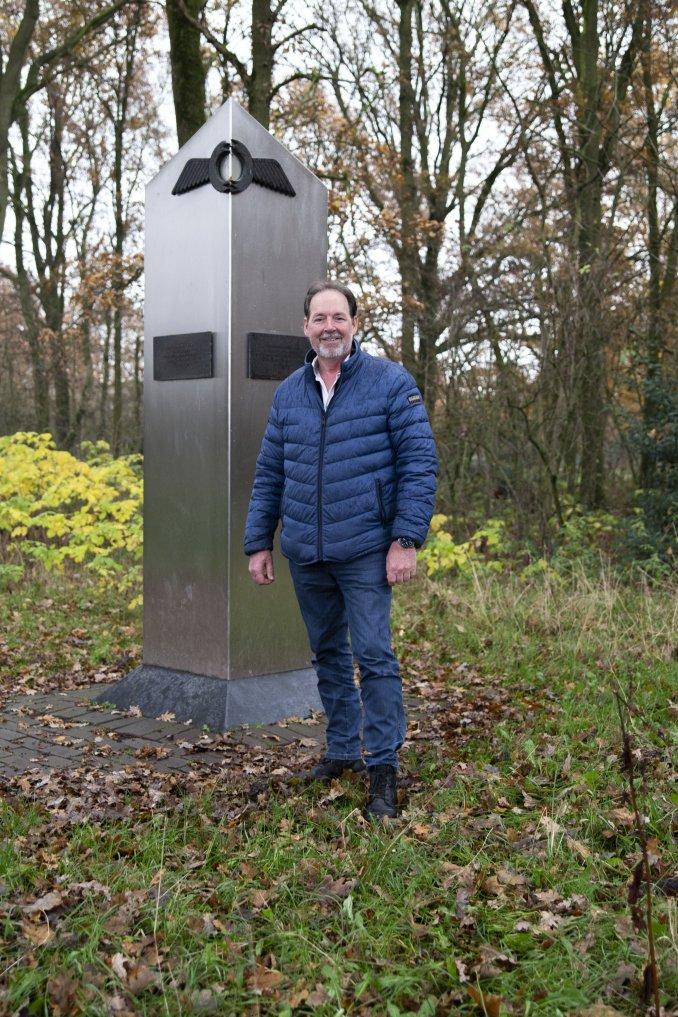 Man naast oorlogsmonument in natuur